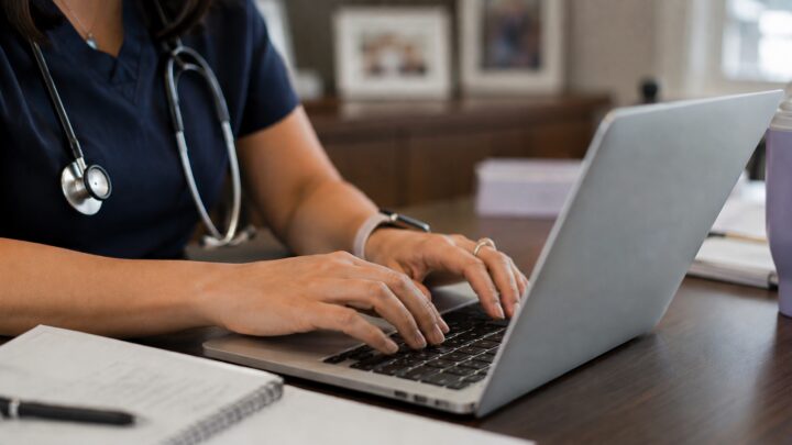 doctor typing on computer